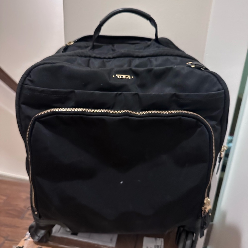 Tumi Oxford compact carry-on black with gold zippers.